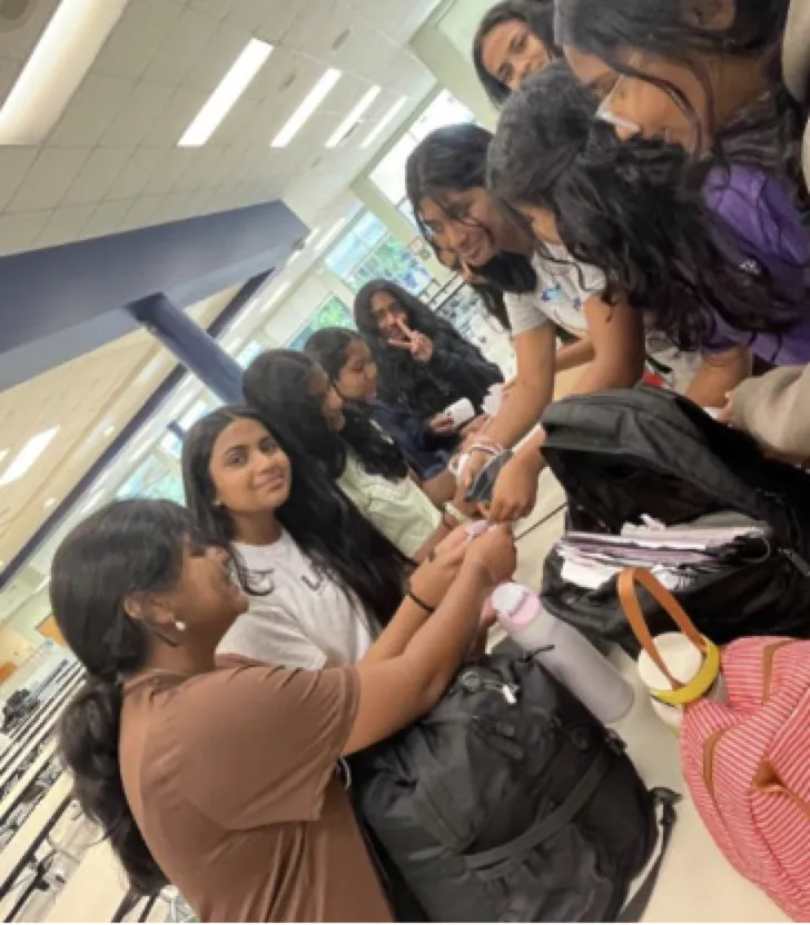 Students linking paper kindness chains together